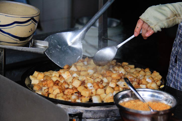 Fried rice cakes being cooked in Vietnam